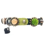 Left-side view of a leather cat collar with a green 3D rose and heart details, featuring a Safety closure with Anti-entanglement protection, adjustable buckle with elastic and Quick release breakaway system.