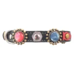 Left-side view of the black leather “Abyss Glow” cat collar featuring luxury red and dark grey stones, silver details and its safety closure with buckle and elastic. The anti-entanglement system includes a quick release breakaway function for safe release, while the ocean-inspired details give the design its distinctive jeweled character.
