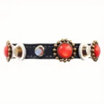 Elegant white‑leather cat collar featuring coral stones, mixed metal studs, soft inner lining and elastic safety clasp.