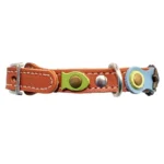Left-side view of the brown leather “Springtime Spark” fantasy cat collar featuring pastel green and blue leather, stars and natural stones. The safety closure combines buckle and elastic for anti-entanglement protection and a quick release breakaway function, while preserving the light, dreamy character of the design.
