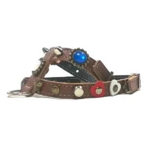 Brown leather dog harness decorated with tricolour stones, heart studs, brass stars and silver spikes, shown from the right side.