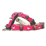Black leather dog harness featuring a vibrant fuchsia overlay with mixed metal studs and spikes, shown from the right side. The contrast between the black base and bright fuchsia gives the harness a fierce, diva‑style attitude.