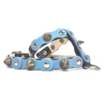 Black leather dog harness with a soft baby‑blue top layer, decorated with mixed metal studs and subtle spikes, shown from the left side. The smooth materials, gentle colour palette and polished hardware create a calm, refreshing look inspired by ocean air and everyday comfort.