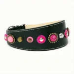 Right‑side view of the artisanal “Pink Blossom Bite” greyhound collar, showing detailed purple fuchsia and pink leather flowers arranged on rich black leather with clean stitching. The tapered shape fits the refined neck of a Whippet, and delivers the same eye‑catching, colorful elegance to Shelties and Australian Shepherds, whose expressive coats and bright personalities match the collar’s bold floral style.