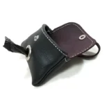 Open black leather poop bag holder showing suede interior, snap closure, and visible waste bag roll.