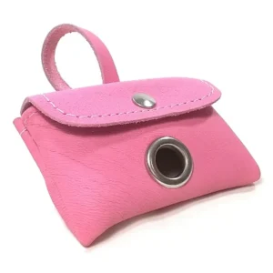 Pink leather dog poop bag holder with stitching and metal grommet, shown from the front with bag ready to pull.