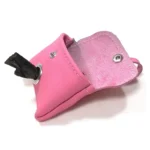 Open pink leather poop bag holder showing suede interior, snap closure, and visible waste bag roll.