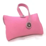 Close‑up of pink leather poop bag holder’s rear strap and snap buttons.